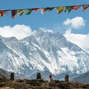 A trekker on their way to Everest Base Camp, Mount Everest is the peak to the left