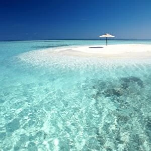 Tropical sandbank and sun umbrella, Maldives, Indian Ocean, Asia