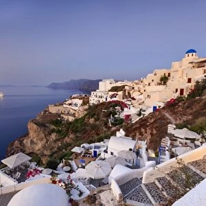 View of the Aegean Sea from the typical Greek village of Oia at dusk, Santorini, Cyclades
