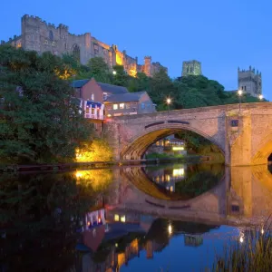 View to the illuminated castle and cathedral across the River Wear below Framwellgate Bridge