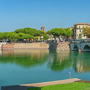 View of Ponte di Tiberio reflecting in Rimini Canal in Borgo San Giuliano district in Rimini, Rimini, Emilia-Romagna, Italy, Europe