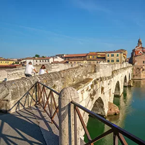 View of Ponte di Tiberio reflecting in Rimini Canal from Borgo San Giuliano, Rimini, Emilia-Romagna, Italy, Europe