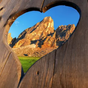 View of the Sass de Putia through a heart shaped hole at dusk, Passo delle Erbe, Dolomites, South Tyrol, Italy, Europe