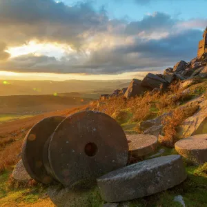 View of sunset and old millstones at Curbar Edge during autumn, Derbyshire, Peak