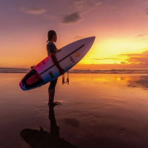 View of surfboarder on Kuta Beach at sunset, Kuta, Bali, Indonesia, South East Asia, Asia