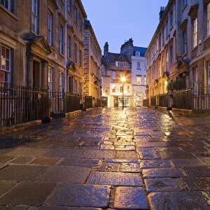 Wet paving stones and Georgian houses along the North Parade buildings, Bath