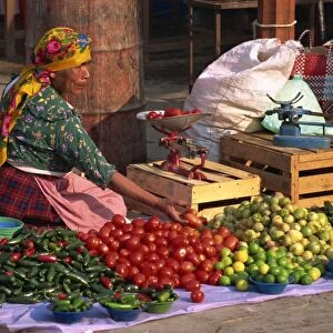 Woman selling vegetables from stall in Tlacolula Market, Oaxaca Region