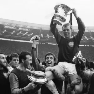 West Ham United captain Bobby Moore is chaired on his teammates shoulders after victory in the 1964 FA Cup