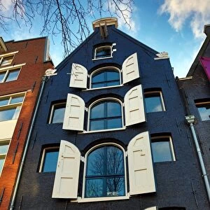 Traditional house with shutters on the windows in Amsterdam, Holland