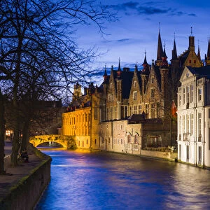Belgium, Bruges, canalside buildings and Belfort Tower, dusk