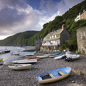 Fishing boats on the pebble beach in Clovelly harbour at dawn, Devon, England. Autumn