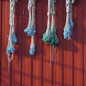 Fishing nets hanging from Rorbuer exterior, Storvagen, Austvagsoya, Lofoten, Nordland