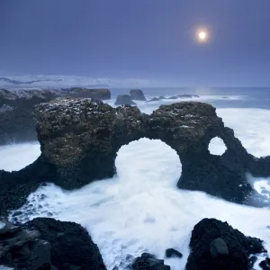 Iceland, characteristic cliff overlooking the sea, illuminated by the moonlight