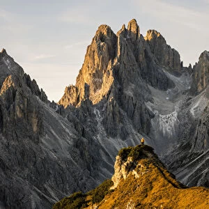 Italy, Veneto, Belluno district, Auronzo di Cadore, hiker surrounded by the peaks of Cadini