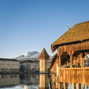Lucerne, Switzerland. KapellbrAocke (Chapel Bridge) on Reuss river and mount Pilatus