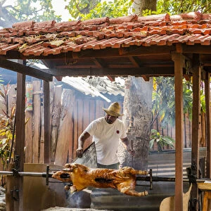 A man roasting a pig in a restaurant in Trinidad, Sancti Spiritus, Cuba