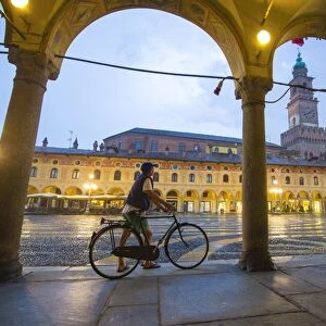 Piazza Ducale, Vigevano, Lombardy, Italy. Rainy sunset and people