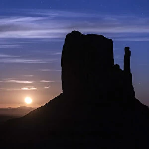 Silhouette of West Mitten Butte at moonrise, Monument Valley, Arizona, USA
