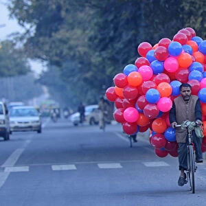 Street Vendor carrying balloons on the back of his bicycle, Delhi, National Capital