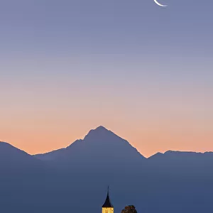 Summer sunrise and moonrise over Church of St. Primoz, Jamnik, Slovenia
