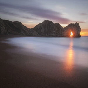 Sunrise through Durdle Door, Jurassic Coast, Dorset, England, UK
