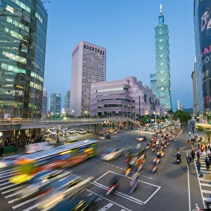 Taiwan, Taipei, traffic in front of Taipei 101 at a busy downtown intersection in