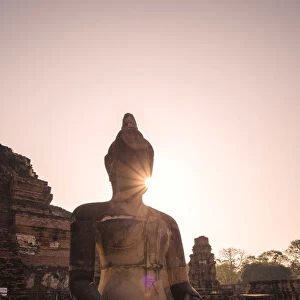 Thailand, Ayutthaya. Buddha statue at sunrise, Wat Mahathat, Ayutthaya historical park