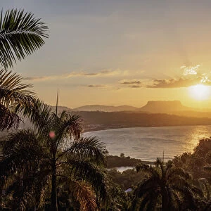 View over Bahia de Miel towards city and El Yunque Mountain, sunset, Baracoa