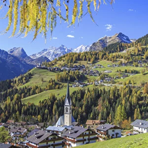 Yellow larches color the villages of Selva of Cadore and Saint Lucia hill in autumn