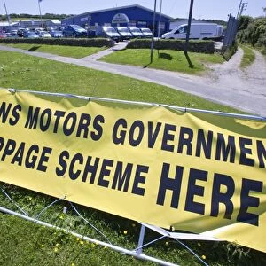 A garage in Cornwall advertising the government scrappage scheme. This scheme offers motorists £2000 to trade in their old car in exchange for a new model. This scheme has been sold as a green initiative, on the grounds that the new cars are