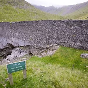 An old abandoned dam near mine workings on Helvellyn Lake district UK