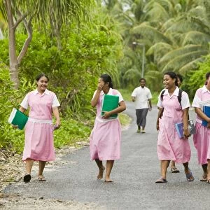School girls walking home from school on Funafuti atol Tuvalu