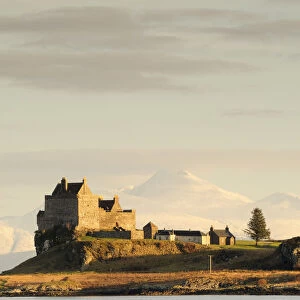 Duart Castle with snow covered Ben Cruachan behind