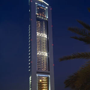 UAE, Dubai Emirates Tower illuminated at night with coloured lights