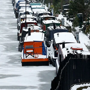 Canal boats are frozen at their berths on the Regents Canal in Maida Vale in London