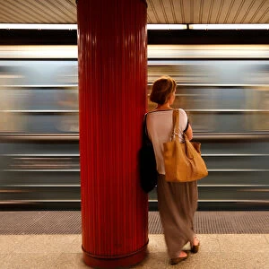 A commuter waits for a train at a subway station in Budapest
