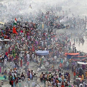 Hindu devotees gather to perform prayers on the banks of the river Ganga on the occasion