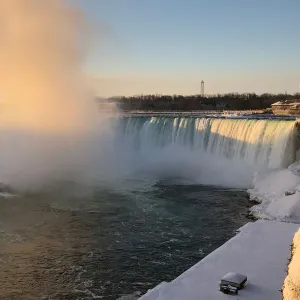 The Horseshoe Falls in Niagara Falls is lit by morning sun as viewed from the Canadian