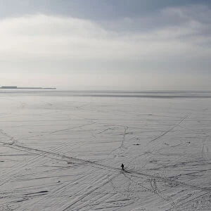A man walks on the ice-covered Gulf of Finland in St. Petersburg