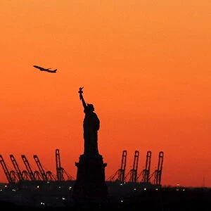 A plane is seen during take off behind the Statue of Liberty in New Yorks Harbor as seen