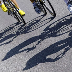 The shadows of riders are cast on the road during the third stage of the 96th Tour