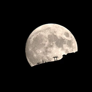 A ski lift at the Kalavrita ski centre on Mount Helmos is silhouetted as the moon