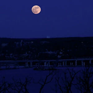 A supermoon full moon is seen above the Hudson River and the Mario M