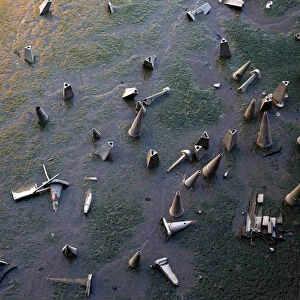 Traffic cones are seen on the bank of the River Thames during low tide in London