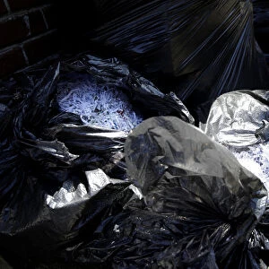 Trash bags filled with shredded paper are pictured outside the former residence of the
