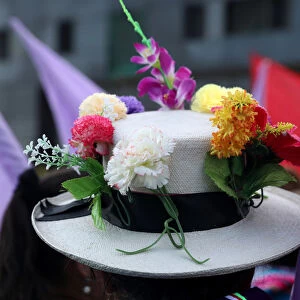 A woman wears a hat with flowers during a demonstration as part of International Women s
