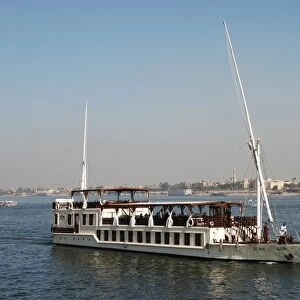 Dahabiya passenger boat cruising on river, River Nile, Luxor, Egypt, january