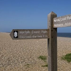 Norfolk Coast Path direction sign on shingle beach, Cley Beach, Cley-next-the-sea, Norfolk, England, april