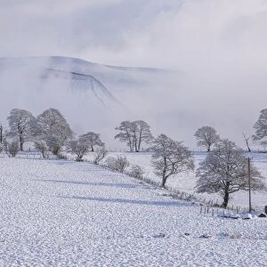 View of farmland and hills covered with snow and mist, Whitewell, Clitheroe, Forest of Bowland, Lancashire, England