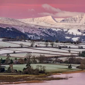 View of snow covered farmland and hills at sunrise, looking from Mynydd Llangorse, Llangorse Lake, Brecon Beacons N. P